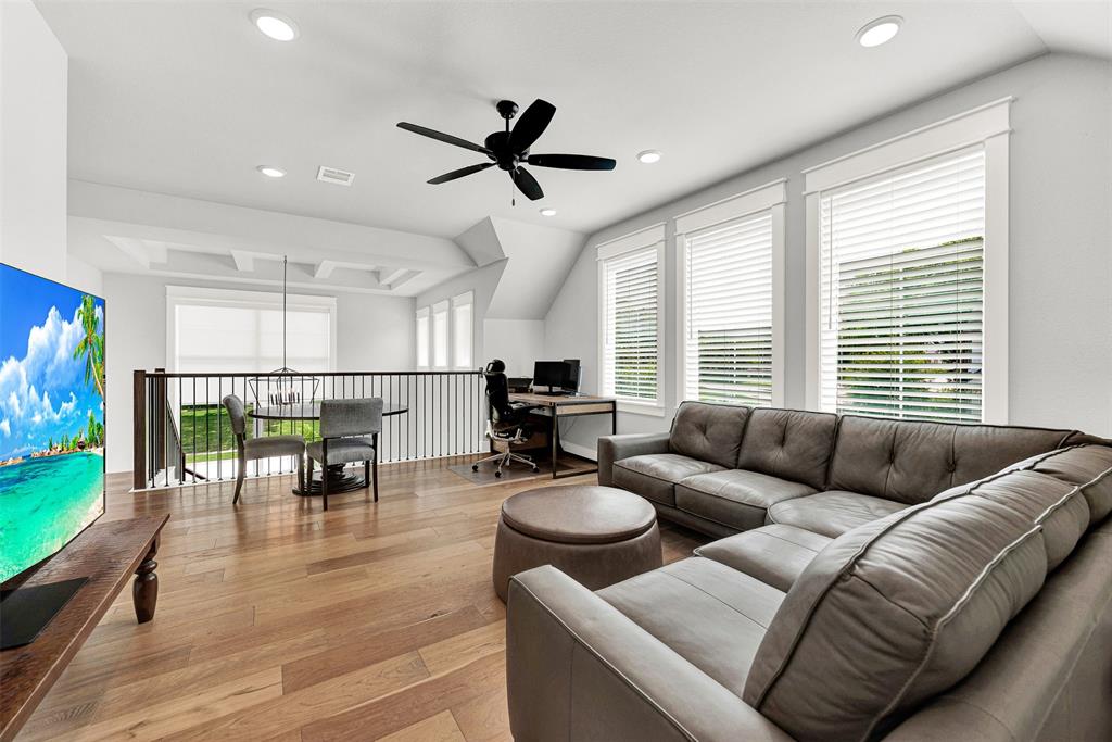 452 Jones Street Grapevine, TX 76051 - Photo 17 of 38 A wrought iron baluster and railing are open to the staircase and foyer below.