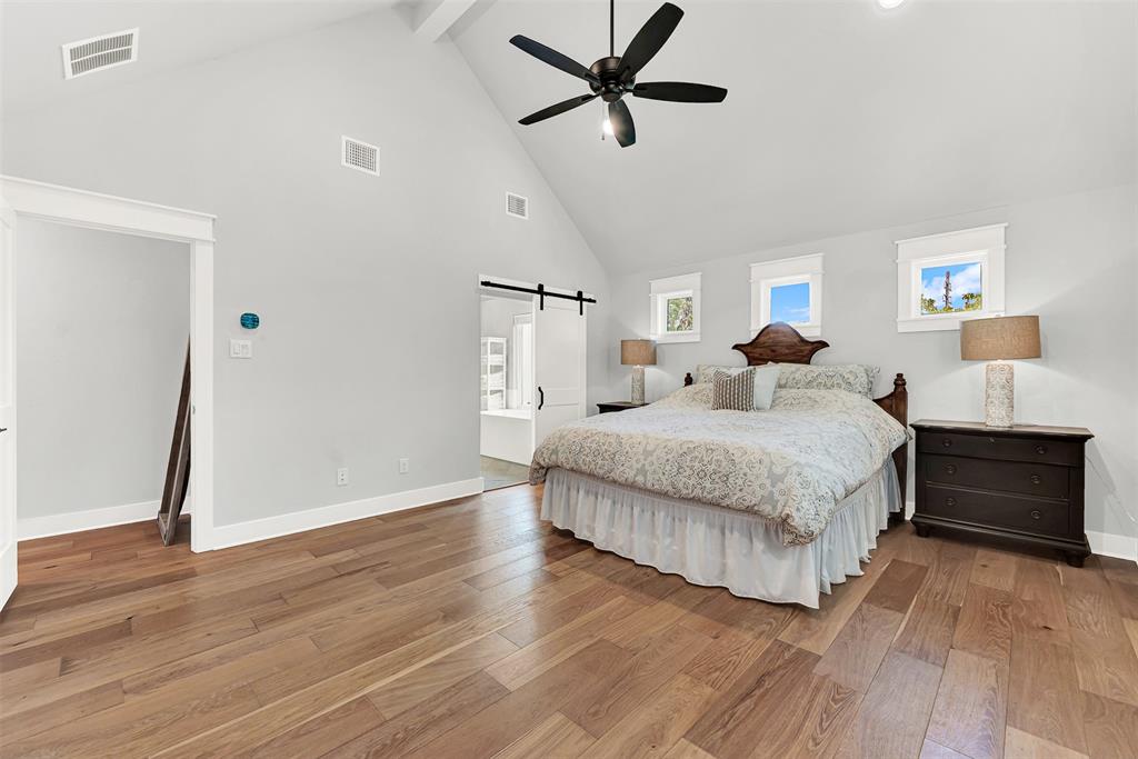 452 Jones Street Grapevine, TX 76051 - Photo 19 of 38 Barn doors invite you to explore the primary bath, and small windows bathe the room with natural light while still being private!
