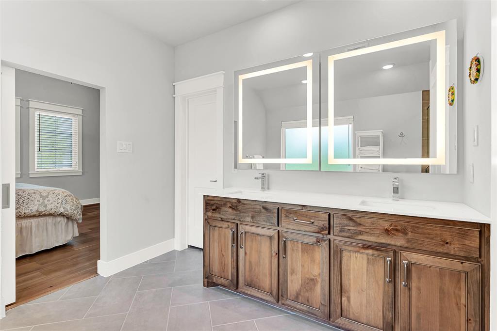452 Jones Street Grapevine, TX 76051 - Photo 22 of 38 The long vanity offers dual sinks, lots of storage and LED backlit mirrors.