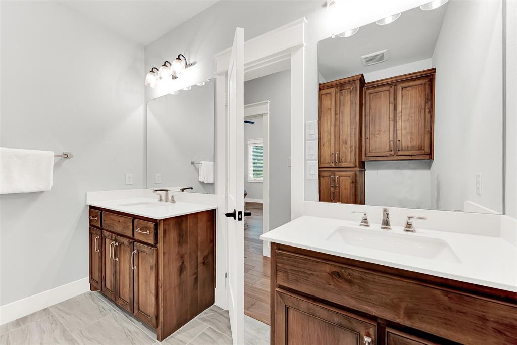 452 Jones Street Grapevine, TX 76051 - Photo 24 of 38 A gorgeous full bath for the secondary bedrooms and flex space offers dual vanities and additional storage space for towels and toiletries.