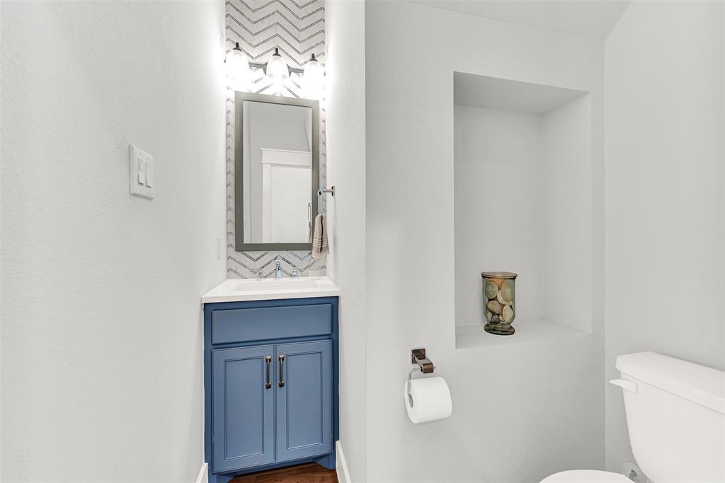 452 Jones Street Grapevine, TX 76051 - Photo 29 of 38 This adorable half bath on the first floor sits neatly under the stairs!