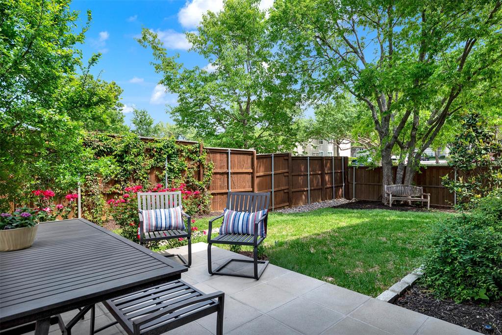 452 Jones Street Grapevine, TX 76051 - Photo 31 of 38 You won't get tired of this view from the back patio, looking across the lush grass to a cozy sitting bench under a shady tree.