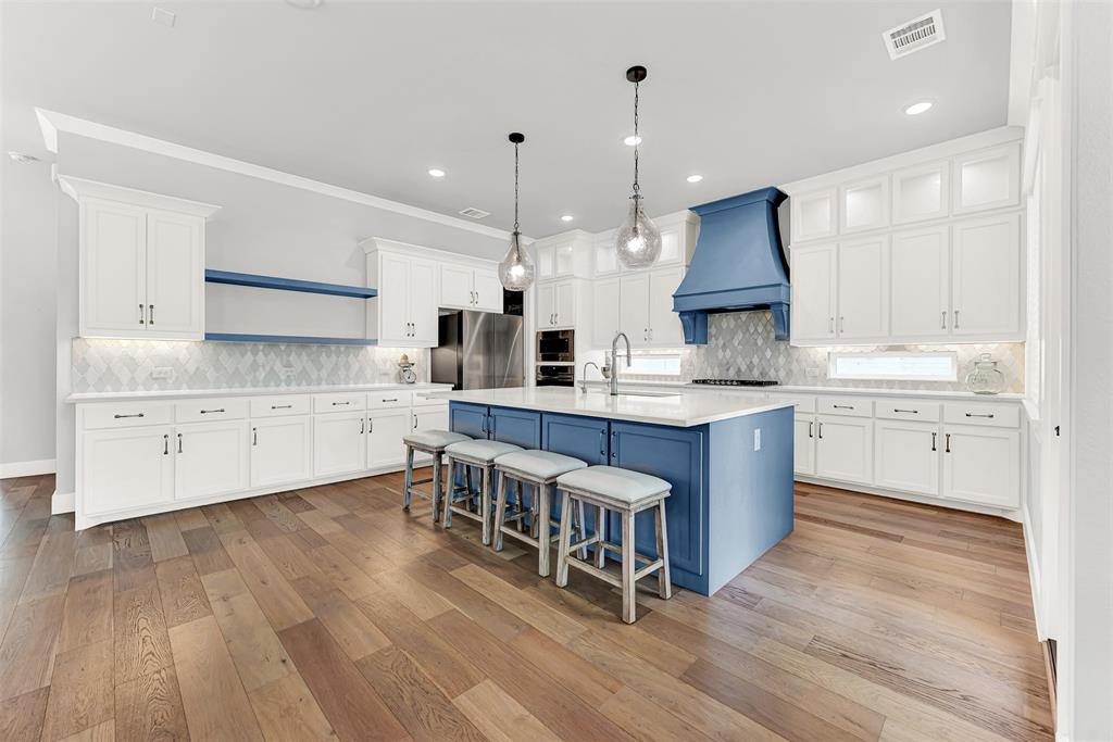 452 Jones Street Grapevine, TX 76051 - Photo 10 of 38 Next stop is the spectacular gourmet kitchen! The large island is ideal for preparing meals, gossiping with friends, helping kids with homework! Don't forget the large counter/butler's pantry to the side with tons of additional storage!