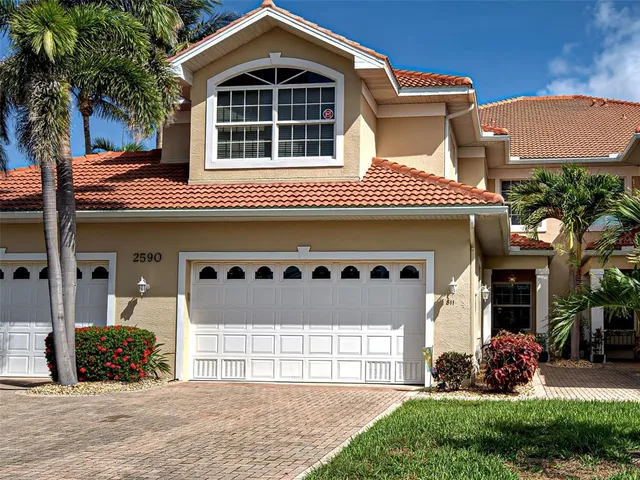 a front view of a house with a yard and garage