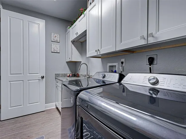 a kitchen with stainless steel appliances granite countertop a sink a stove and cabinets