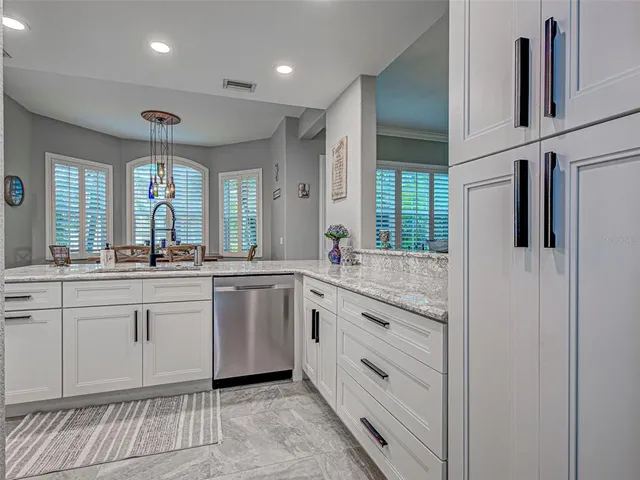 a kitchen with stainless steel appliances granite countertop a stove and a sink