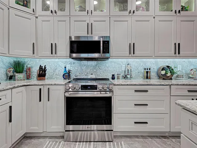 a dining room with wooden floor a chandelier a wooden table and chairs