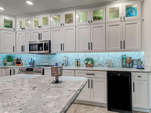 a living room with furniture and large windows