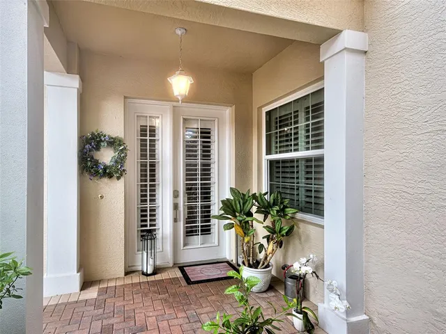a living room with furniture and potted plant