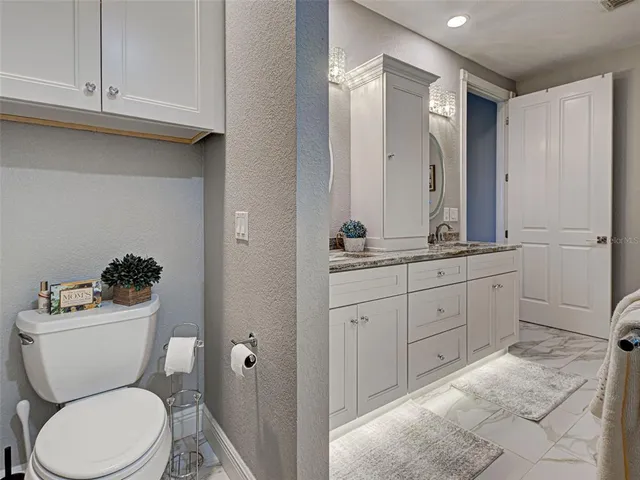 a dining room with furniture a rug and a floor to ceiling window