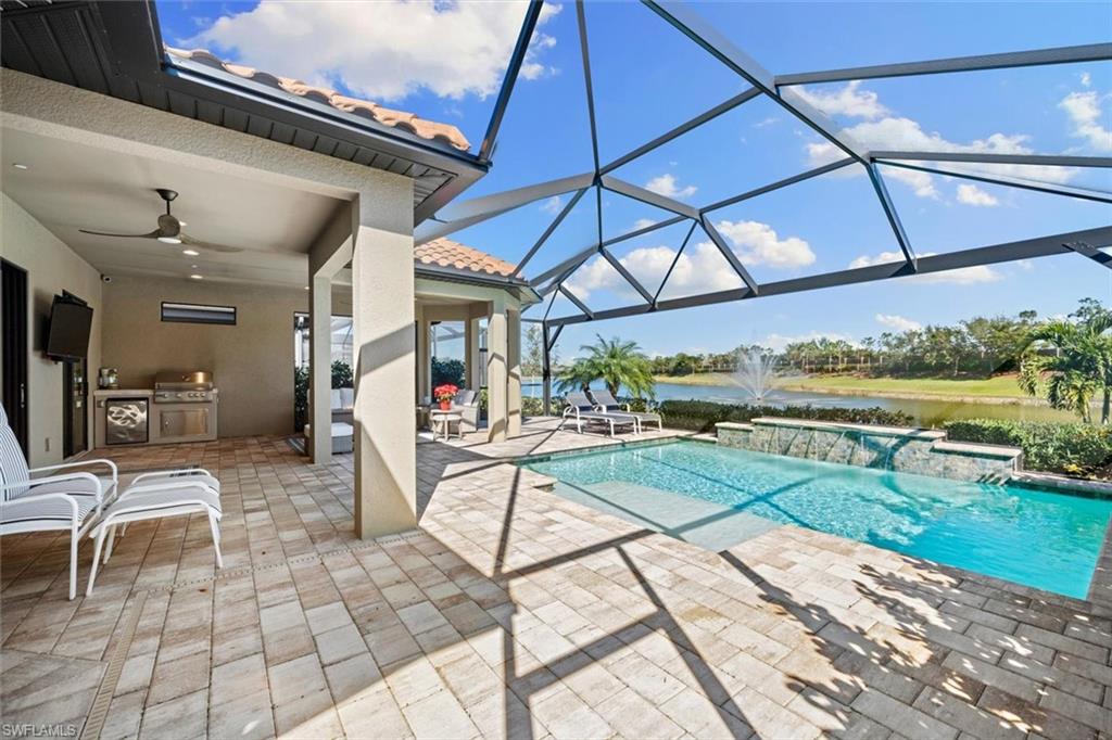 10244 Coconut Road Estero, FL 34135 - Photo 31 of 37 a view of a patio with a table and chairs under an umbrella