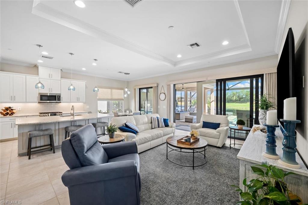 10244 Coconut Road Estero, FL 34135 - Photo 6 of 37 a living room with kitchen island furniture and a large window