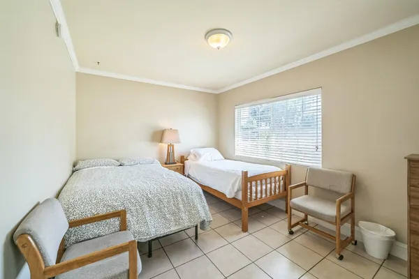 a bedroom with two beds and a window