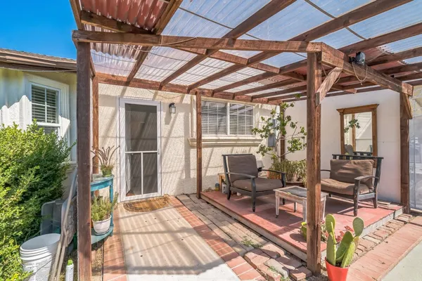a view of a porch with chairs and couches with wooden floor