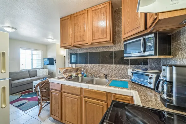 a kitchen with a stove a sink and a refrigerator