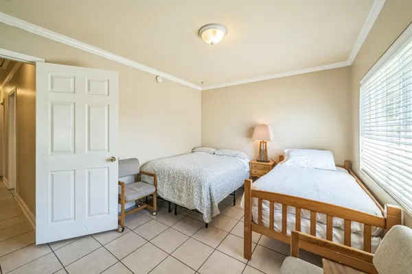 a bedroom with two beds and a window
