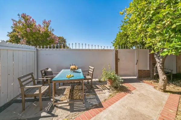a view of a chairs and table in a backyard