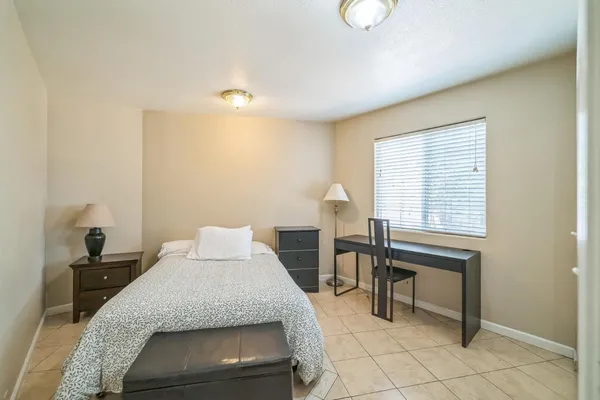 a bedroom with a bed and a table in it