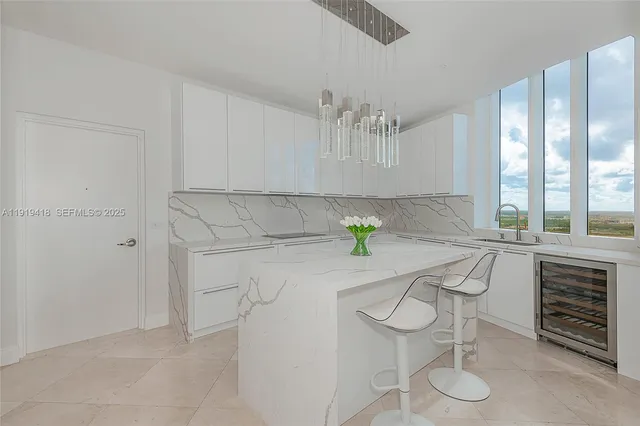 a kitchen with stainless steel appliances a sink a stove cabinets and a counter top space