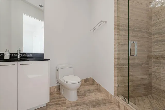 a bathroom with a granite countertop sink and toilet