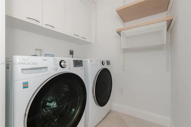 a view of a house with a yard and potted plants