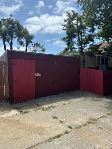 a front view of a house with a tree