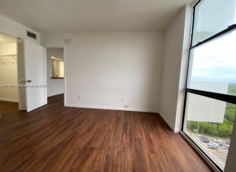 13499 Biscayne Boulevard, Unit 1507 North Miami, FL 33181 - Photo 17 of 34 a view of empty room with wooden floor and fan