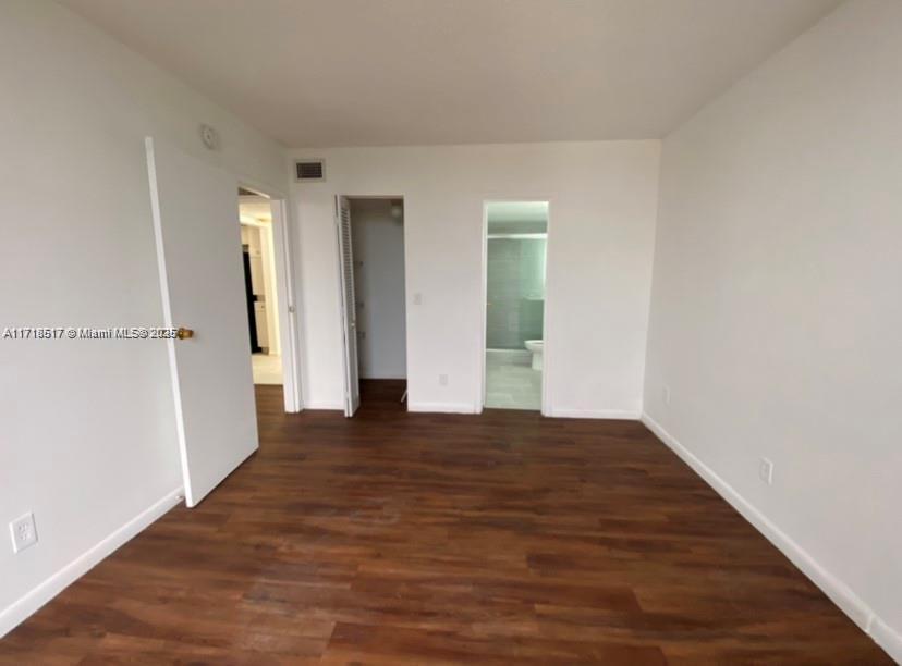 13499 Biscayne Boulevard, Unit 1507 North Miami, FL 33181 - Photo 24 of 34 a view of an empty room with wooden floor