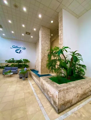 a lobby with furniture and potted plant