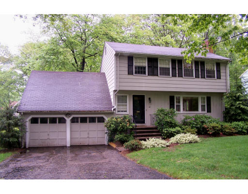 28 Gilbert Road Needham, MA 02492 - Photo 1 of 1 a front view of a house with a yard and garage