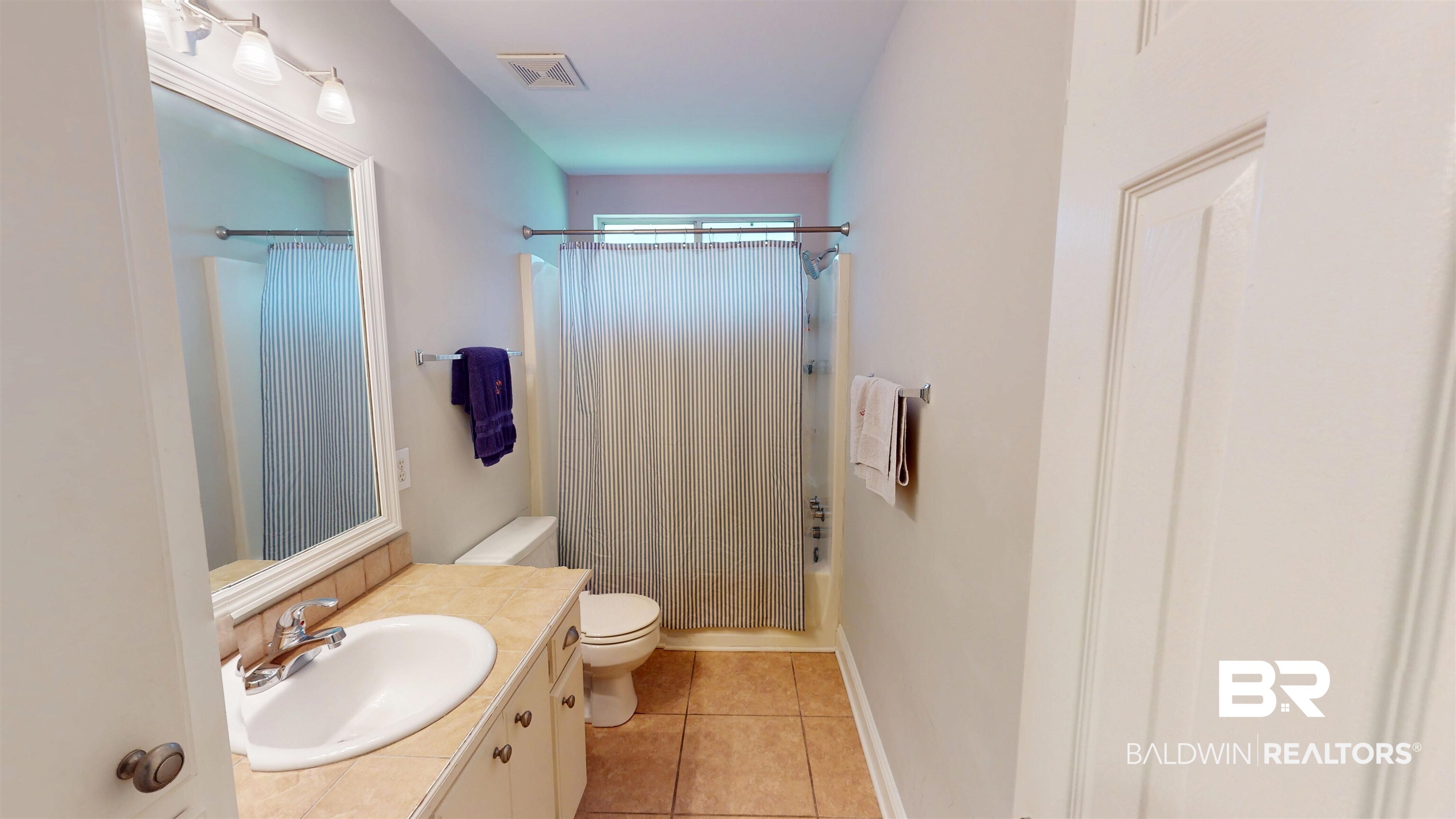 51 Bishop Lane South Mobile, AL 36608 - Photo 17 of 19 Full bathroom featuring shower / tub combo, light tile patterned floors, and vanity
