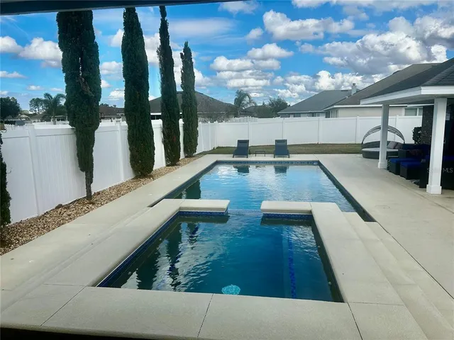 a view of a house with backyard porch and sitting area