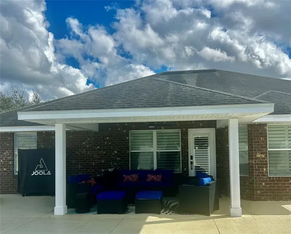 a view of swimming pool with red chairs