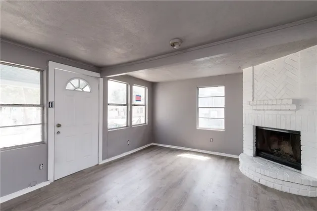 an empty room with windows and closet