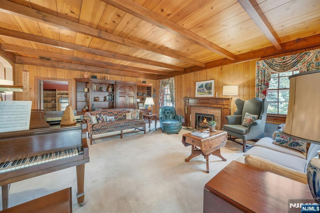 174 Paramus Road Paramus, NJ 07652 - Photo 18 of 45 a living room with furniture a fireplace and a table