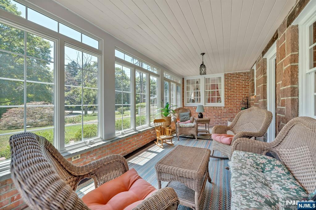174 Paramus Road Paramus, NJ 07652 - Photo 19 of 45 a living room with furniture and a floor to ceiling window