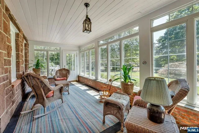 a living room with furniture and floor to ceiling windows