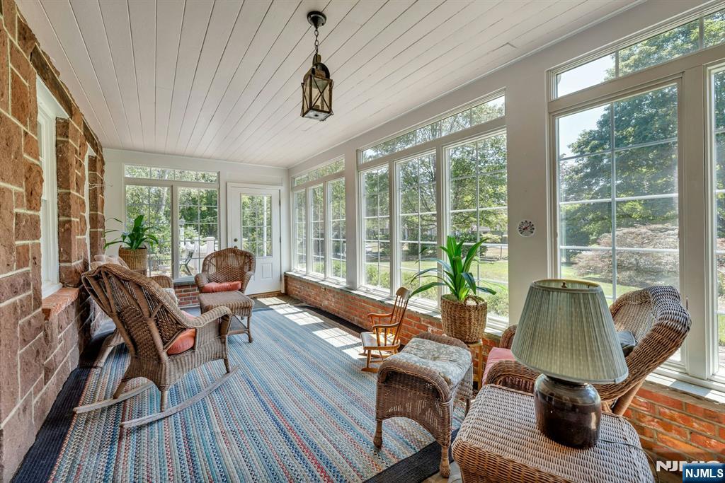 174 Paramus Road Paramus, NJ 07652 - Photo 20 of 45 a living room with furniture and floor to ceiling windows