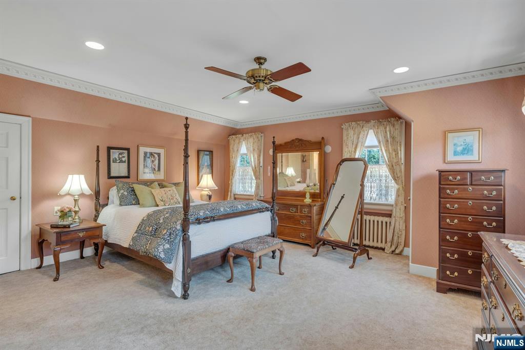 174 Paramus Road Paramus, NJ 07652 - Photo 27 of 45 a bedroom with a bed and a chandelier