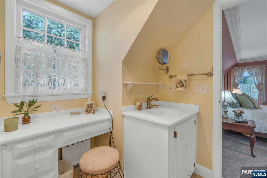 174 Paramus Road Paramus, NJ 07652 - Photo 30 of 45 a bathroom with a sink a toilet and a mirror