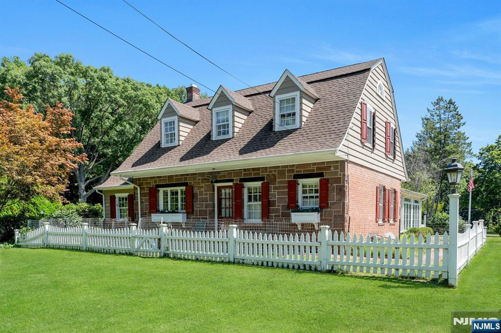174 Paramus Road Paramus, NJ 07652 - Photo 4 of 45 a front view of a house with a garden