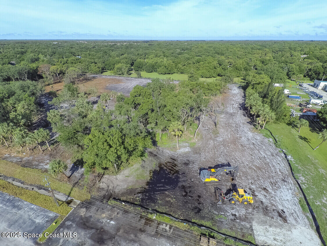 3200 Aurora Road Melbourne, FL 32934 - Photo 1 of 1 an aerial view of a houses with a yard