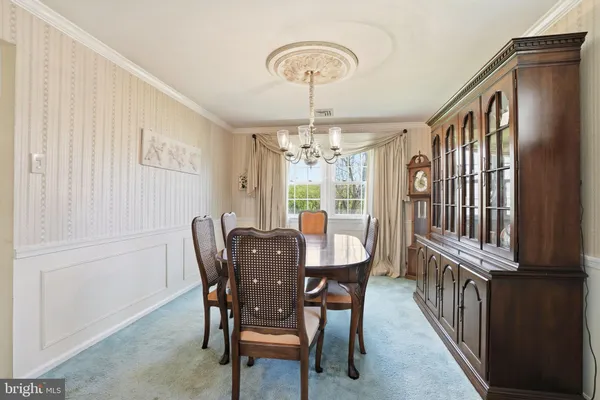 a open kitchen with stainless steel appliances granite countertop a stove a sink a refrigerator and white cabinets with wooden floor