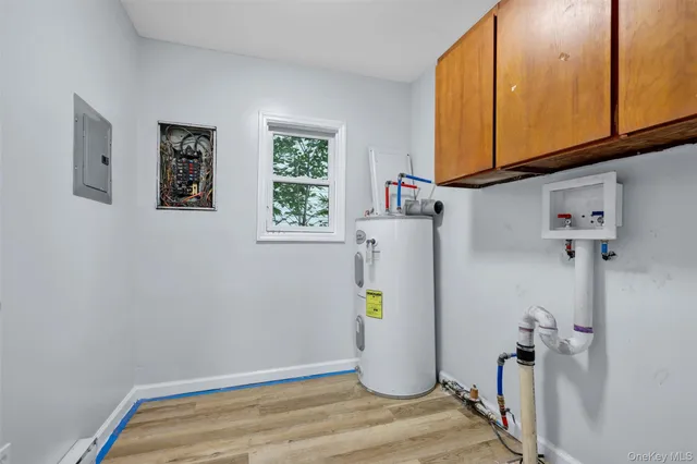 a view of storage and utility room with a window