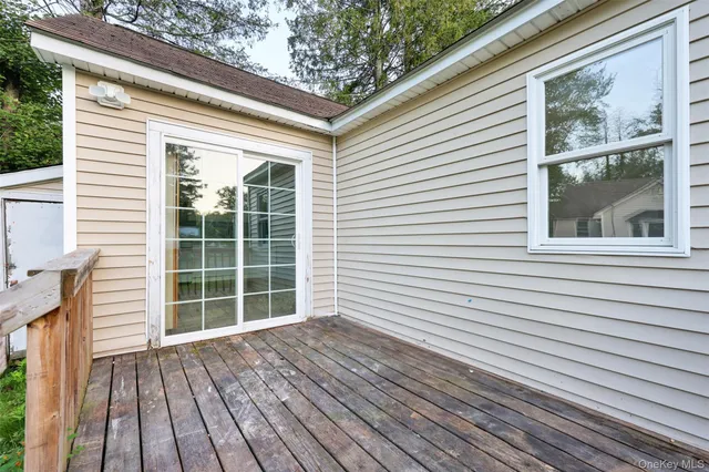 a view of a house with wooden deck