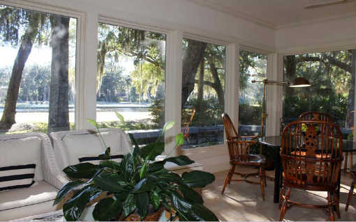 49 Sea Marsh Road Fernandina Beach, FL 32034 - Photo 11 of 24 a living room with patio furniture and floor to ceiling windows