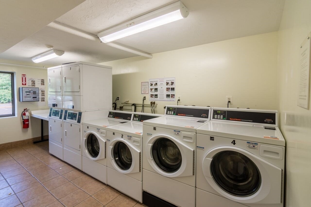 103 Grove Street, Unit 337 Rockland, MA 02370 - Photo 14 of 16 a view of washer and dryer with kitchen in the background