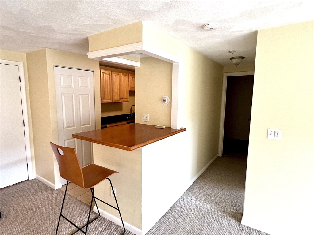 103 Grove Street, Unit 337 Rockland, MA 02370 - Photo 6 of 16 a kitchen with a table and chairs