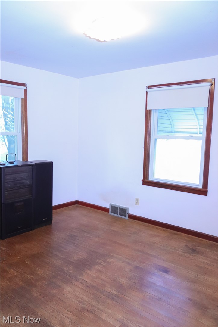 5880 Jaycox Road North Ridgeville, OH 44039 - Photo 12 of 21 downstairs bedroom featuring dark hardwood flooring and a healthy amount of sunlight