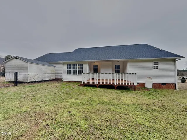 a backyard of a house with table and chairs